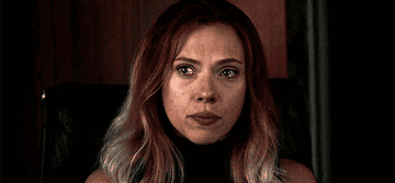 A close up of Natasha Romanoff as she clenches her jaw and tears fill her eyes