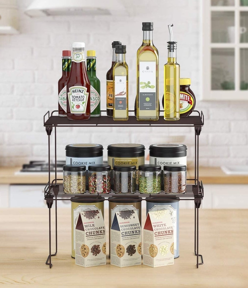 Two shelves stacked on top of one another with cooking supplies on each level