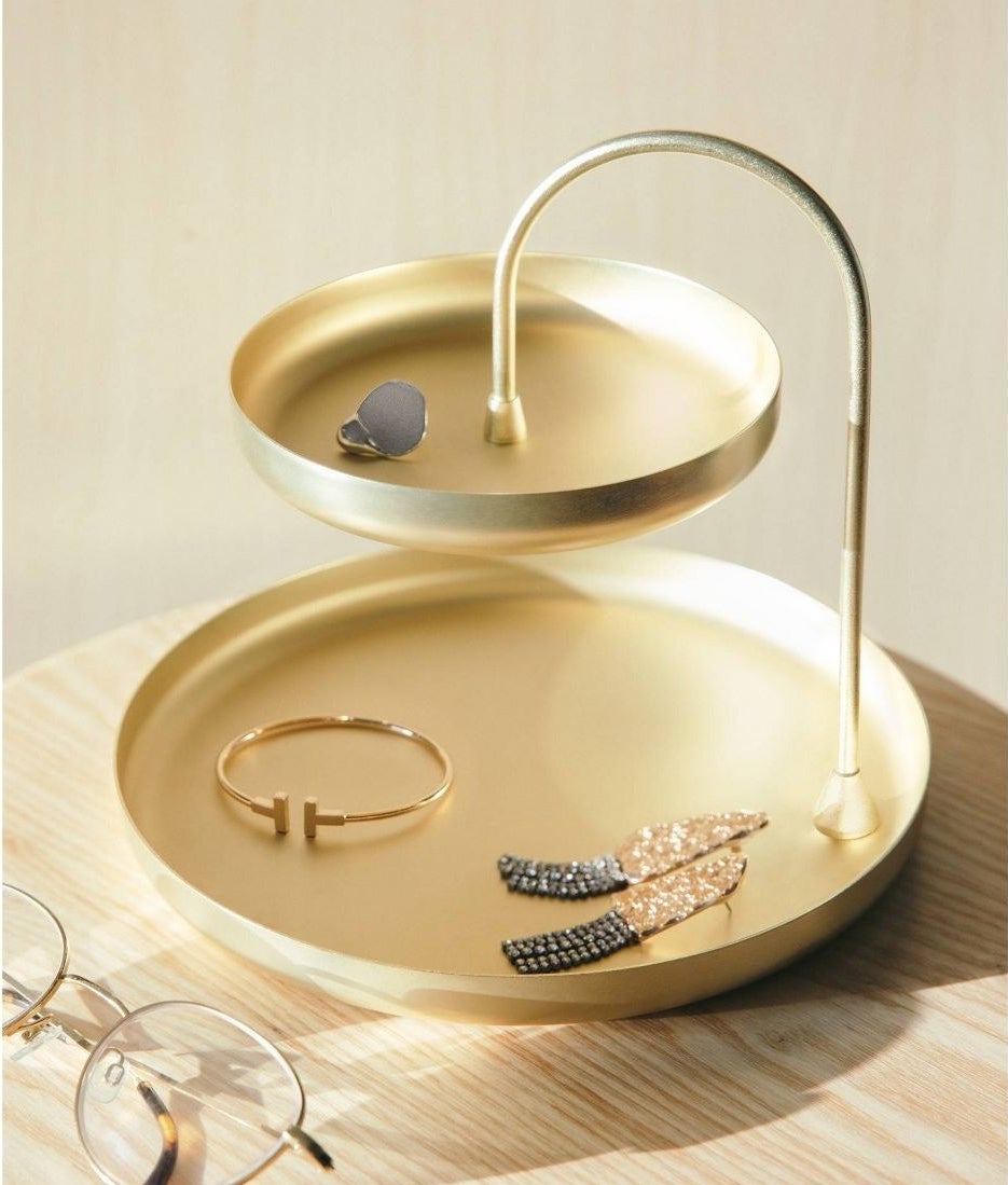 a two-tiered brass jewelry tray