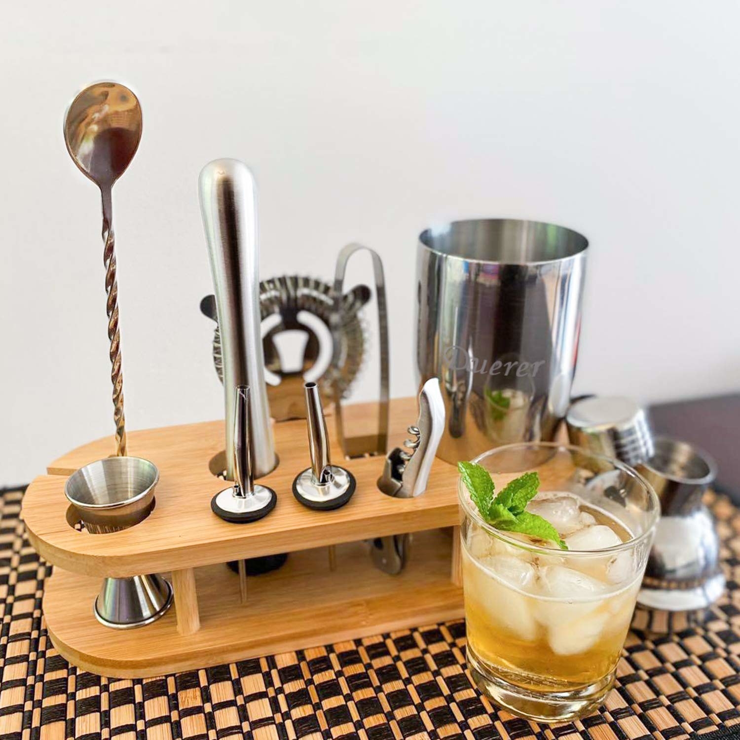 An 11-piece cocktail maker set with a bamboo stand and a cocktail set beside it