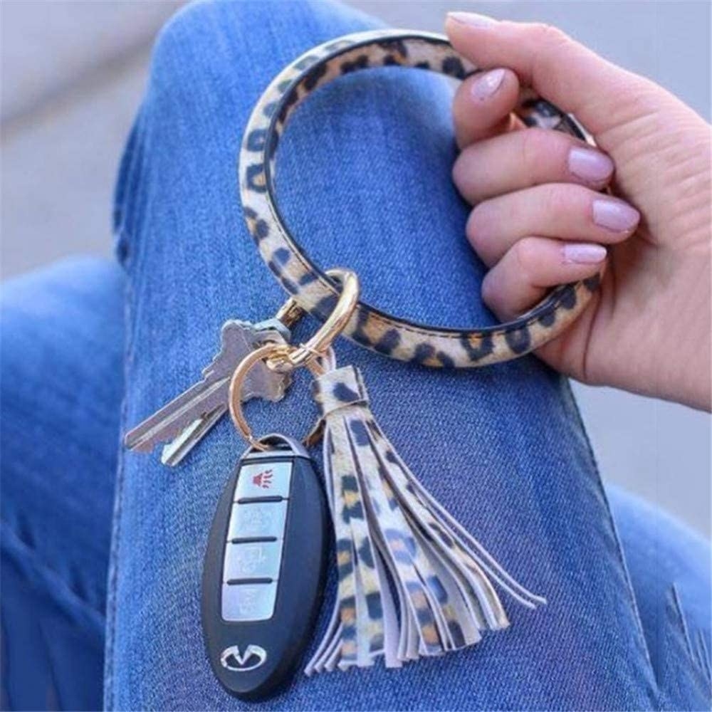 A bracelet-like keychain with a leopard print, containing car and house keys