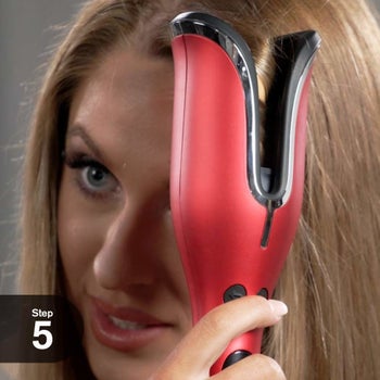 Model using curling iron on hair