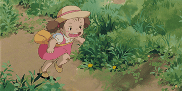 Studio Ghibli character running through a grassy field
