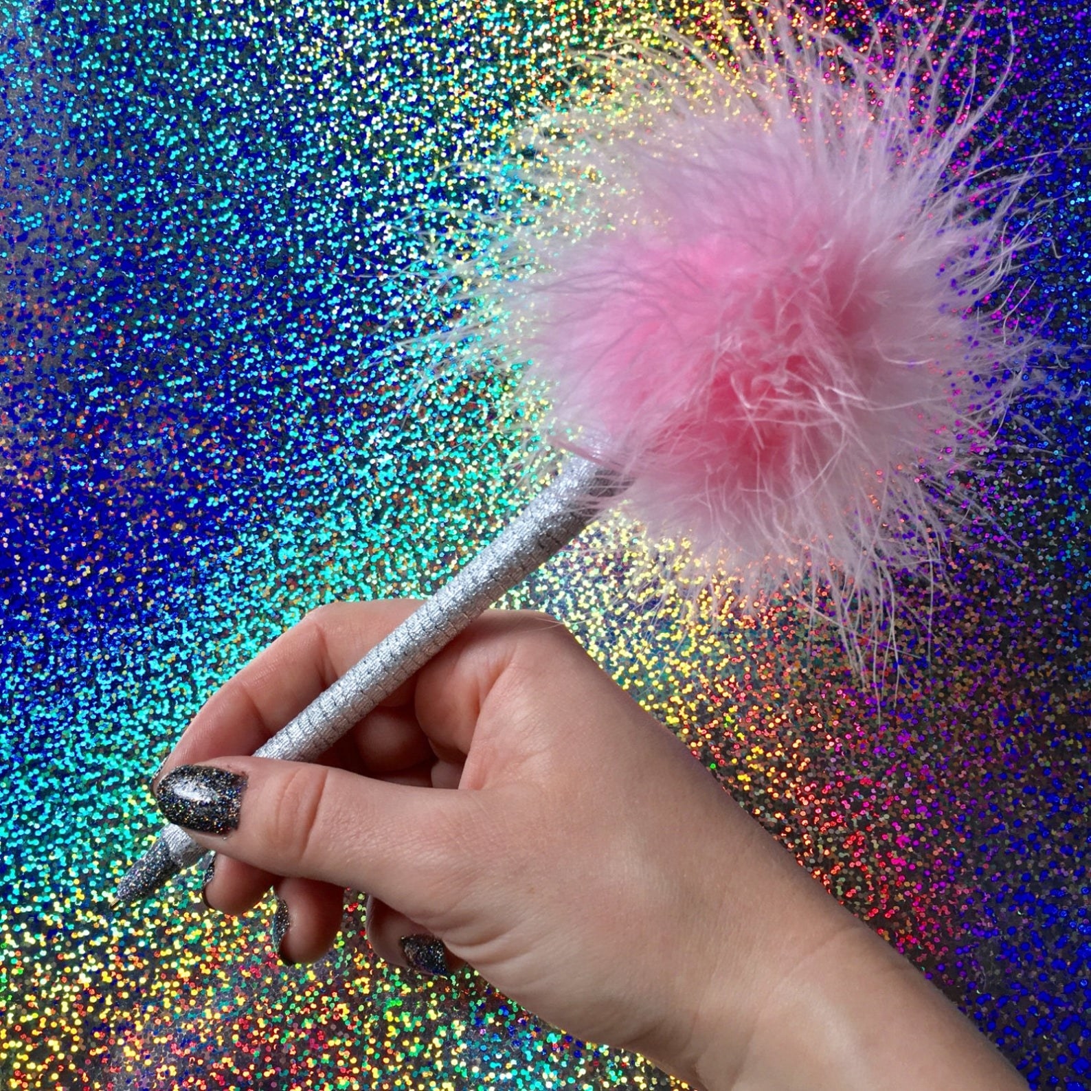 person holding a pink fluffy pen