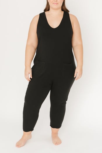 a model wearing the sleeveless black jumpsuit 