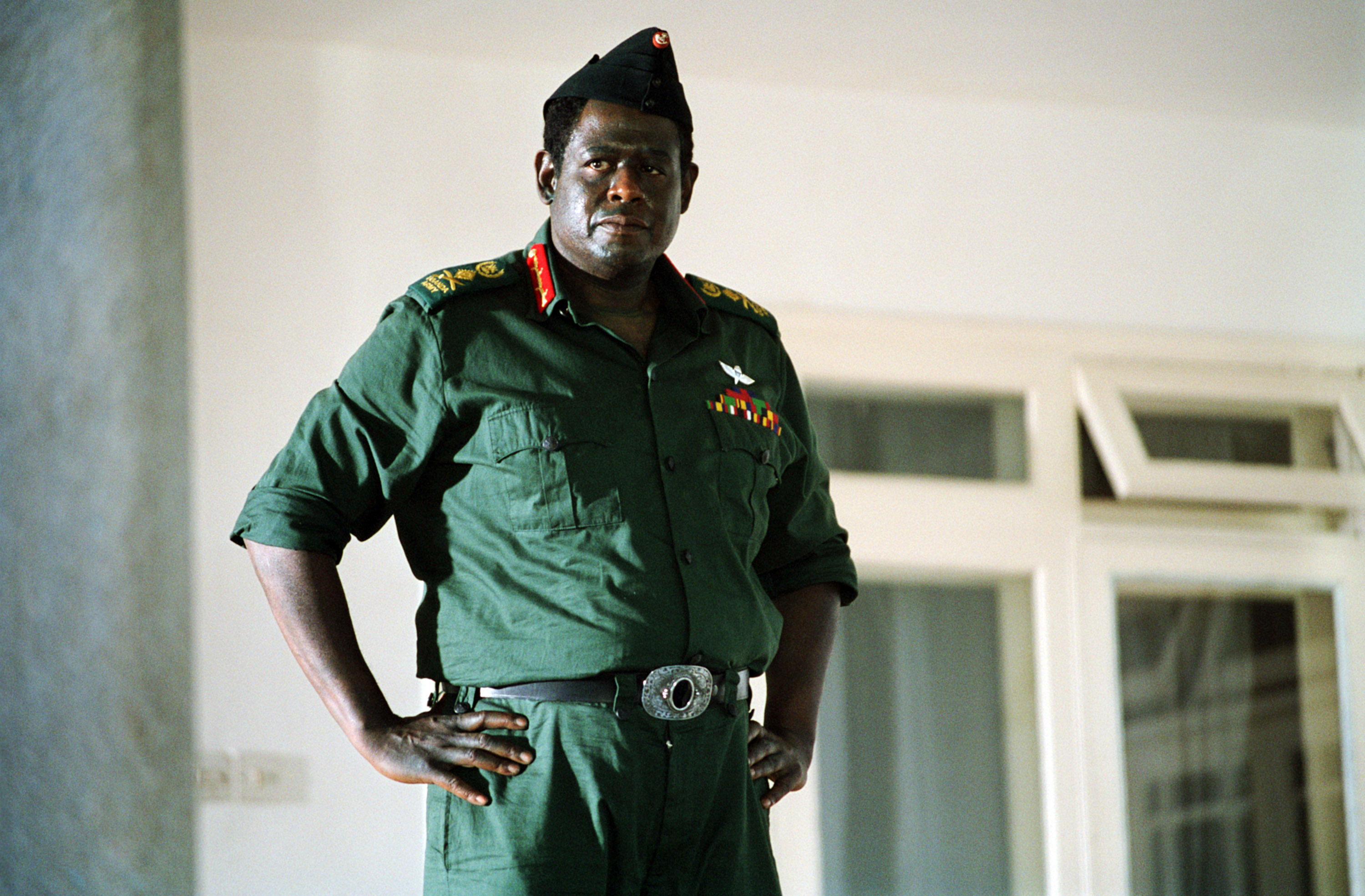 Forest Whitaker stands dressed as Idi Amin