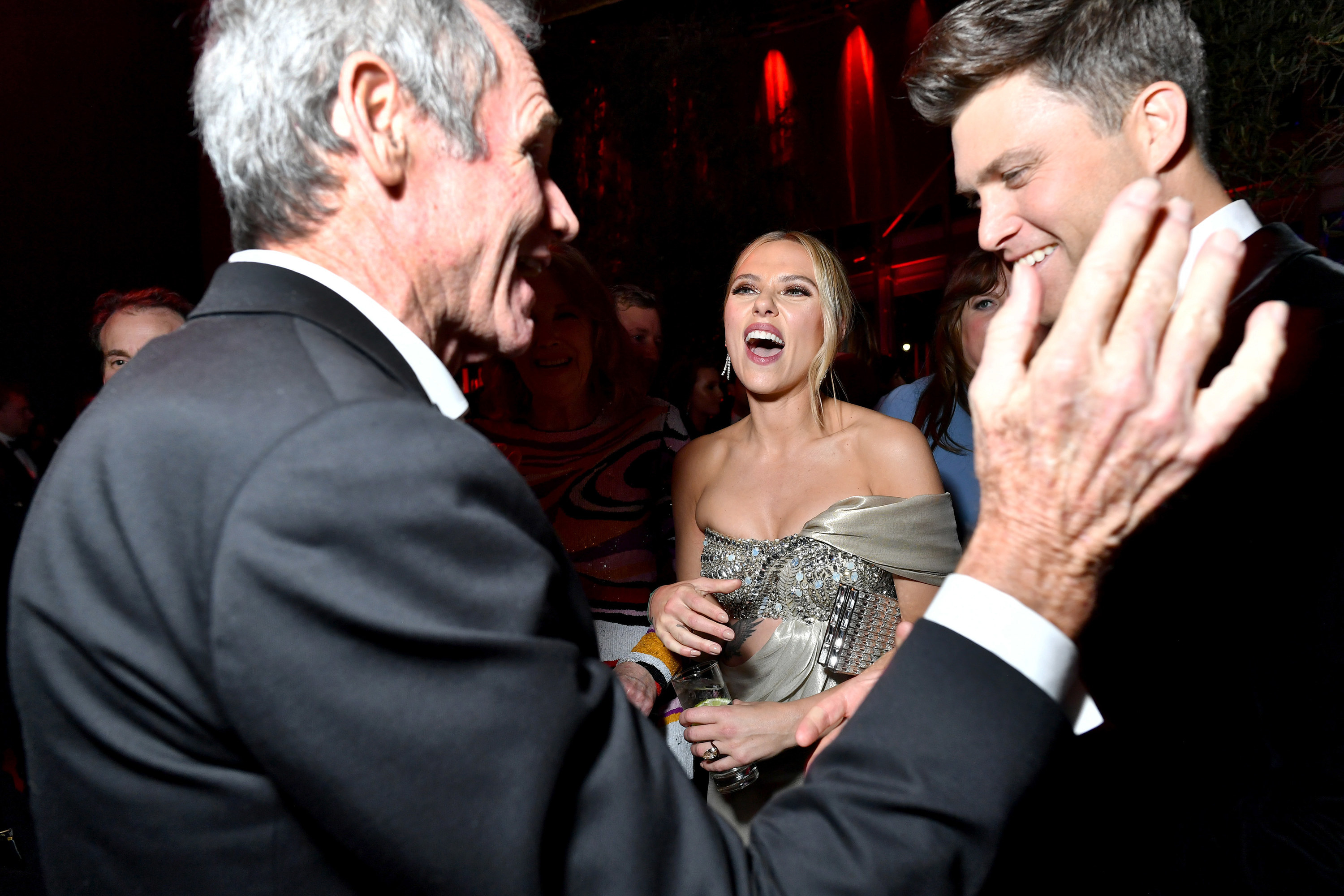 the couple chatting with another party attendee