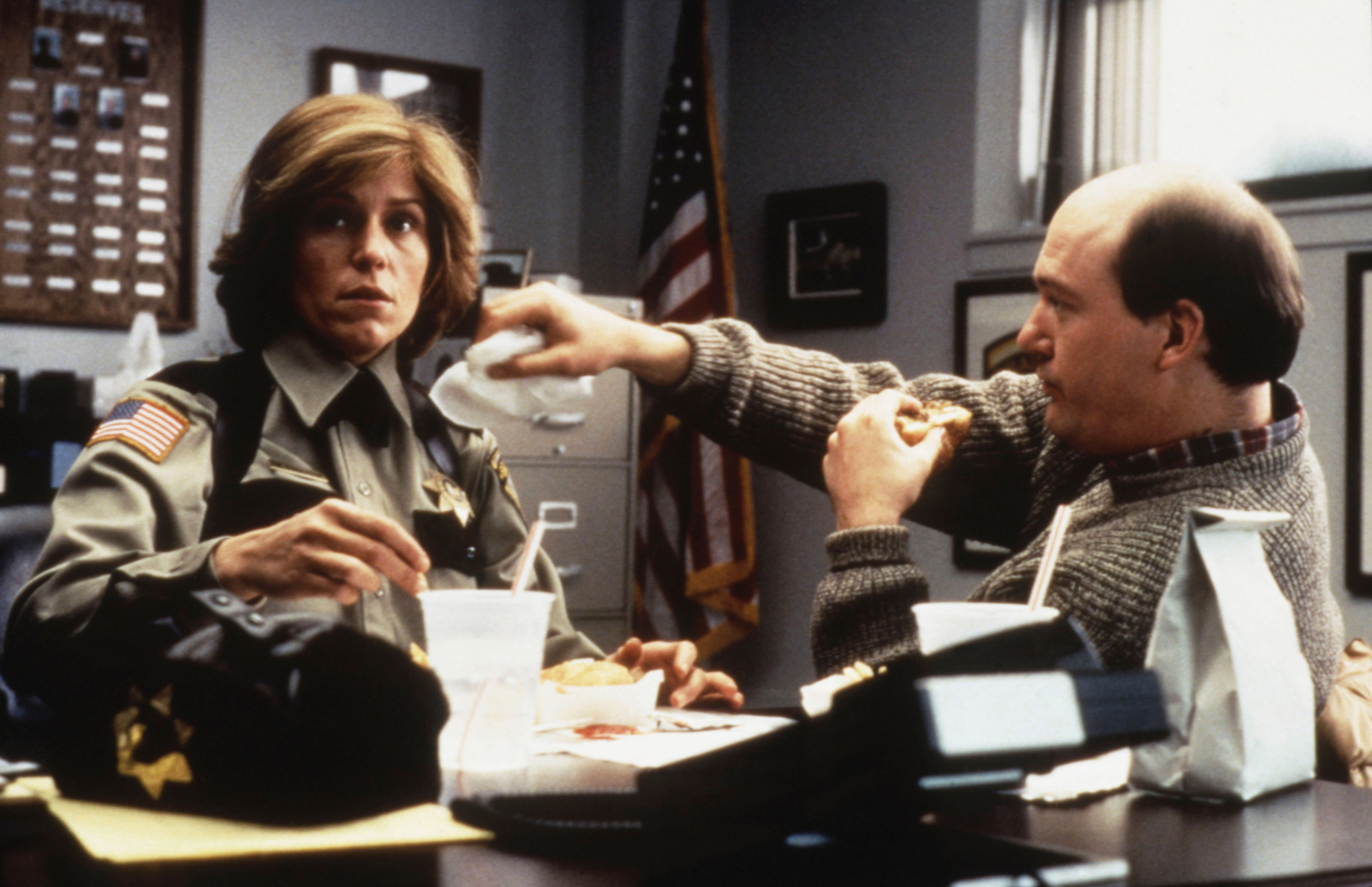 Frances McDormand sits at her police desk with John Caroll Lynch