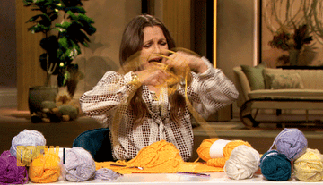 Drew Barrymore going through a ball of yarn with a distressed espression