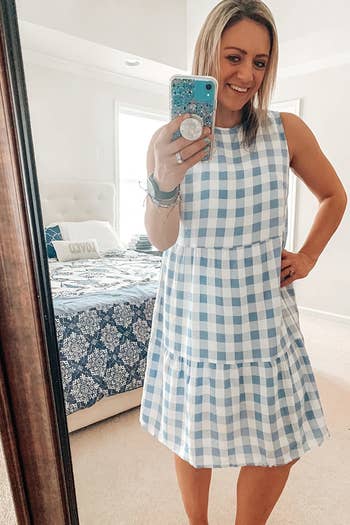 a reviewer wearing the dress in light blue and white 