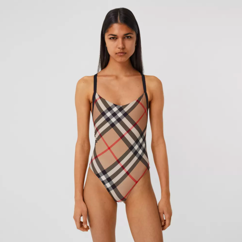 model wearing the Burberry swimsuit in the classic beige plaid print the designer brand is known for