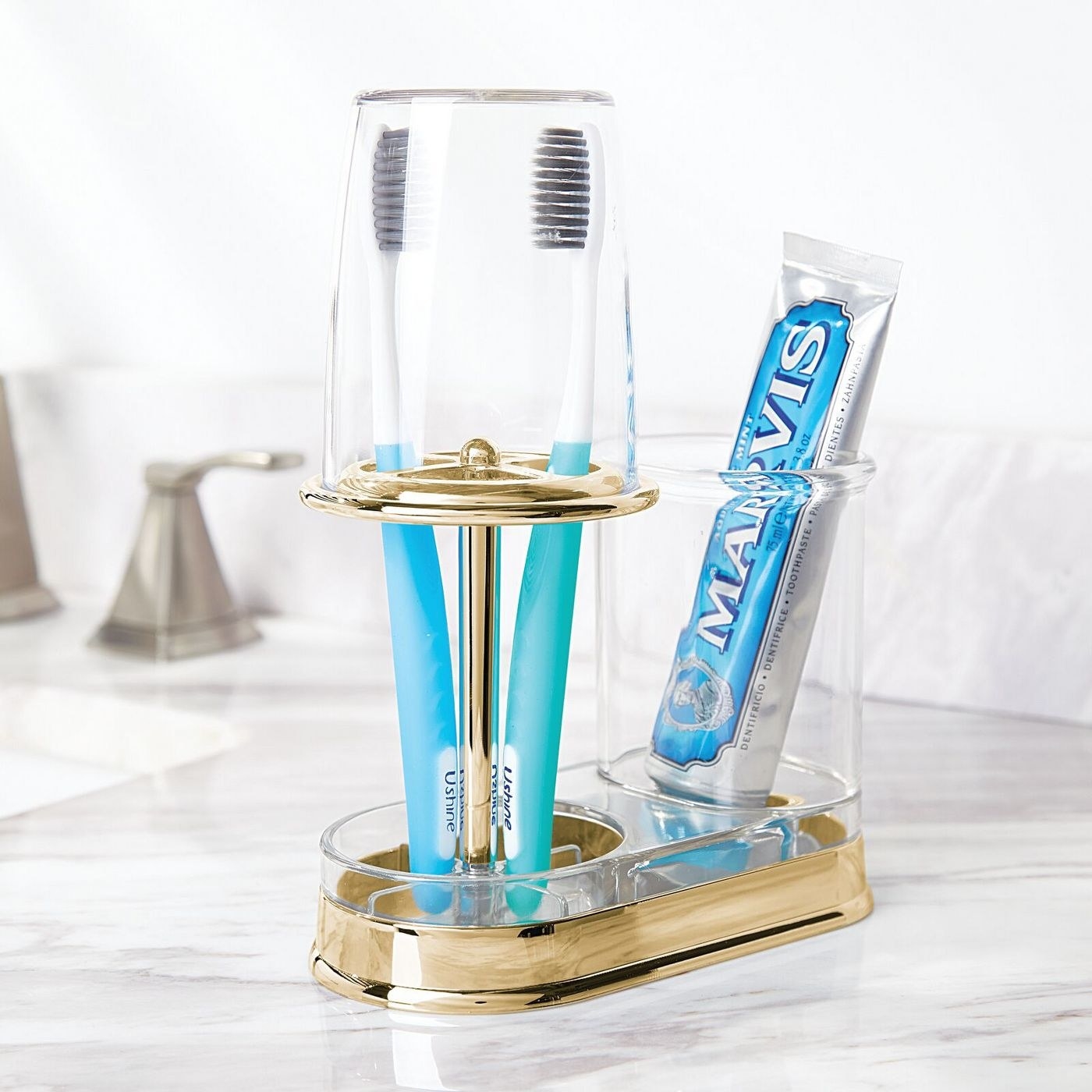 a god toothbrush, toothpaste, and rinse cup holder