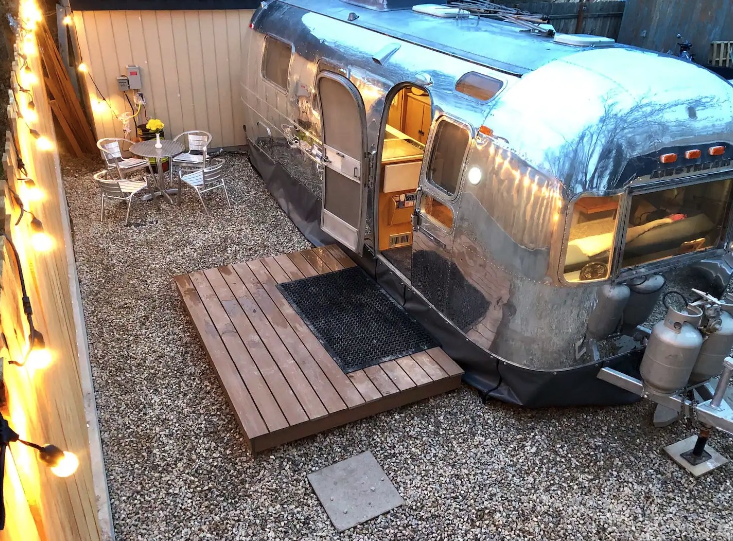 An Airstream with a patio and seating area