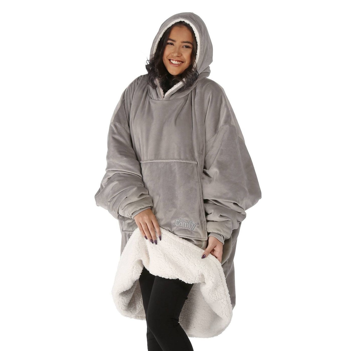 A model wearing a gray Comfy wearable blanket hoodie