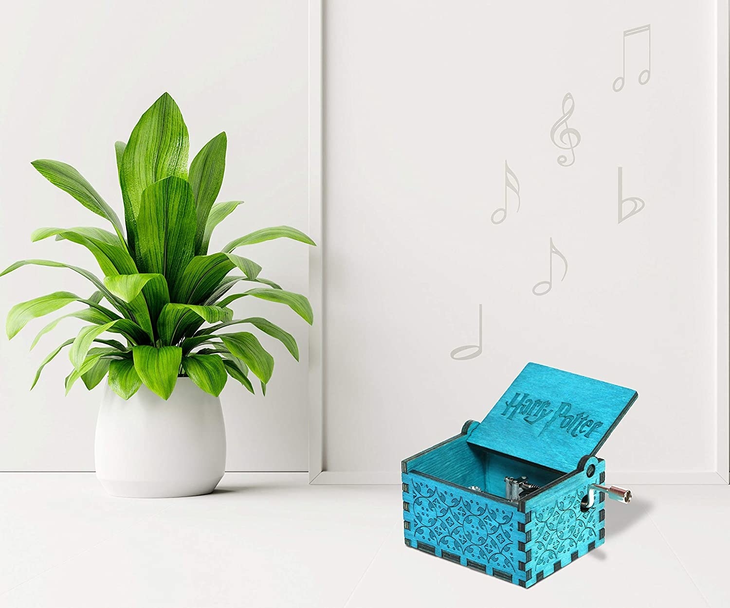 A music box on a table next to a plant