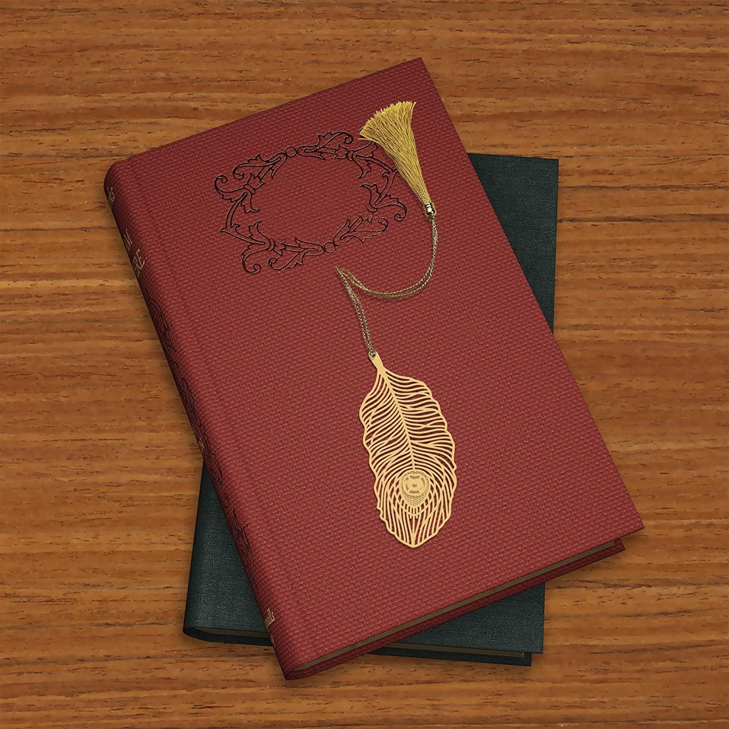 A brass leaf bookmark on top of a book