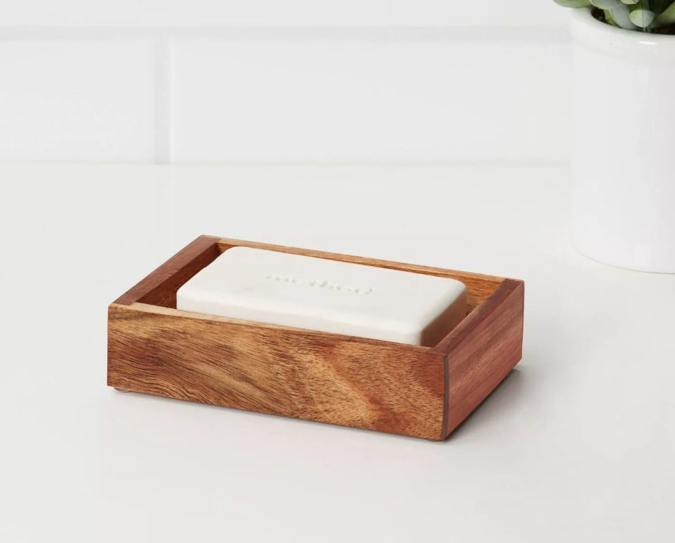 Dark wooden soap holder with white bar of soap