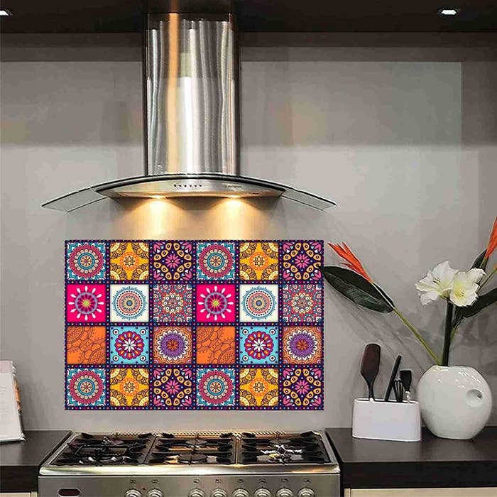 A rectangular wall sticker with Mandala designs on it. It&#x27;s stuck on the wall behind a stove.