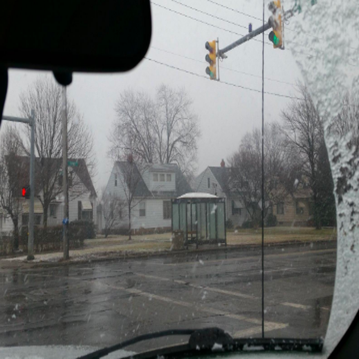 photo of windshield from inside of car, in the snow, with a clear view thanks to the wipers 