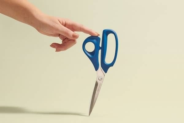The scissors balanced on a table
