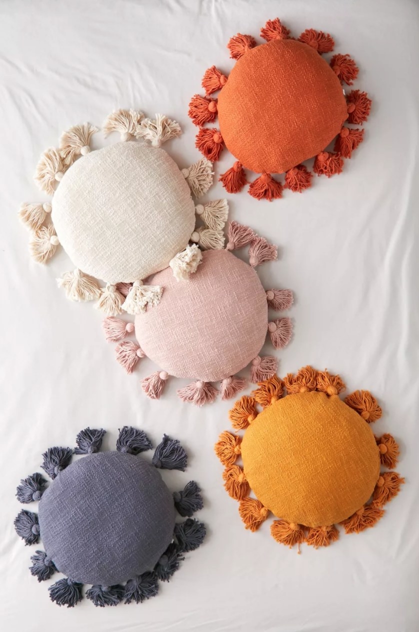 the round throw pillows in different colors