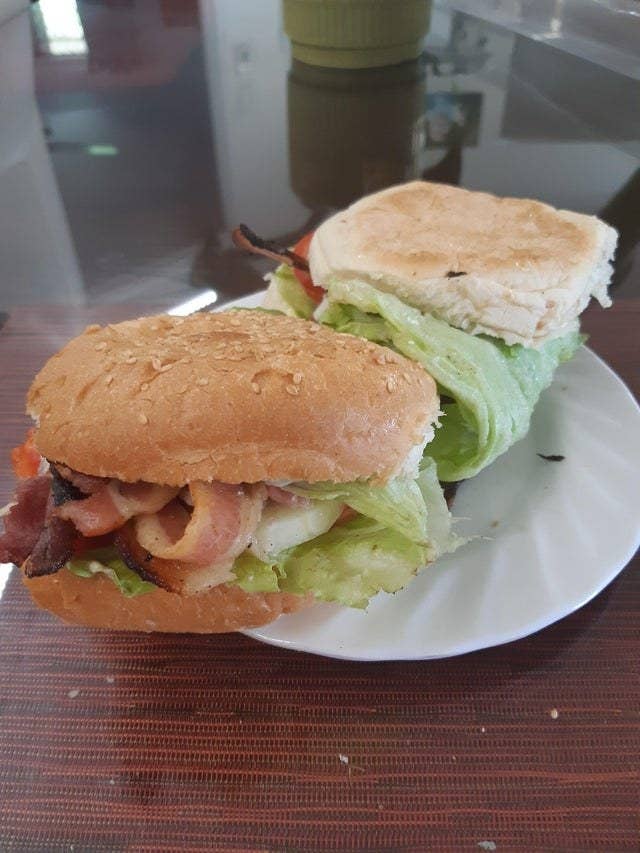 A sandwich with the ingredients folded in a piece of lettuce.