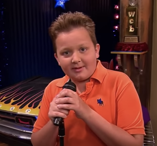 Gibby speaking into a mic