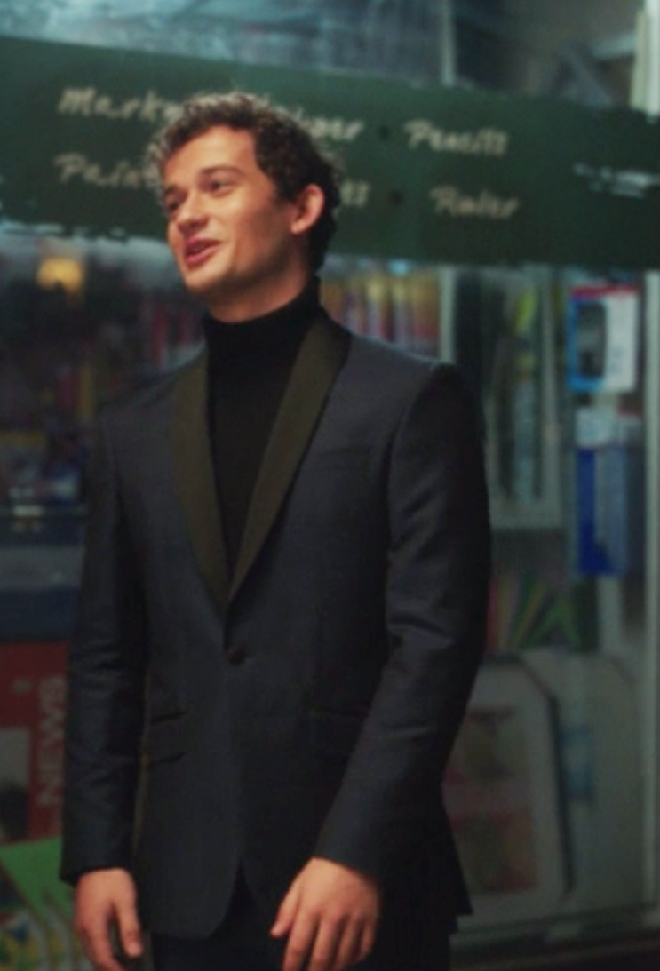 Obie wears a turtleneck under a tight fitted blazer