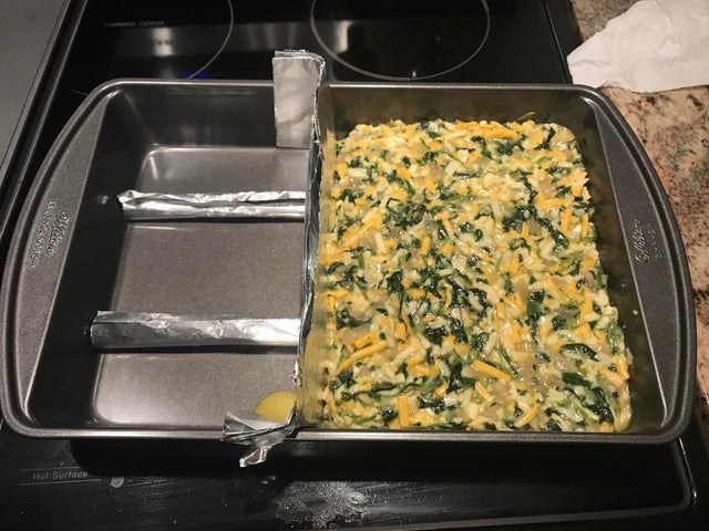 Tin foil creating a divider in a baking pan.