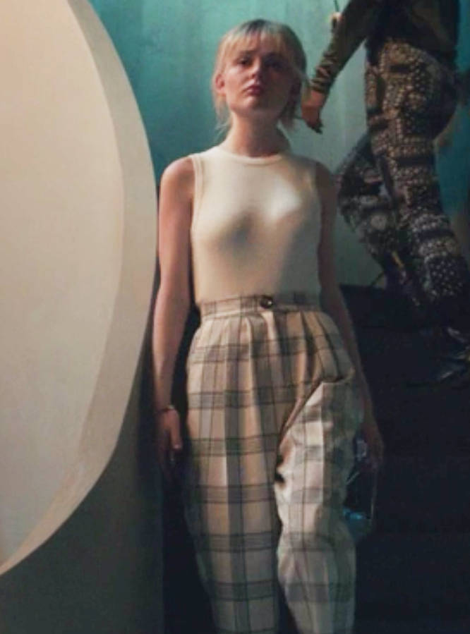 Audrey wears a tank top tucked into high waisted plaid pants