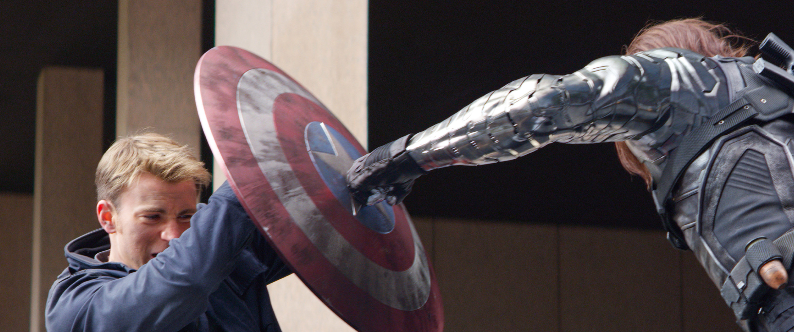 Captain America blocks a punch from the Winter Soldier with his shield