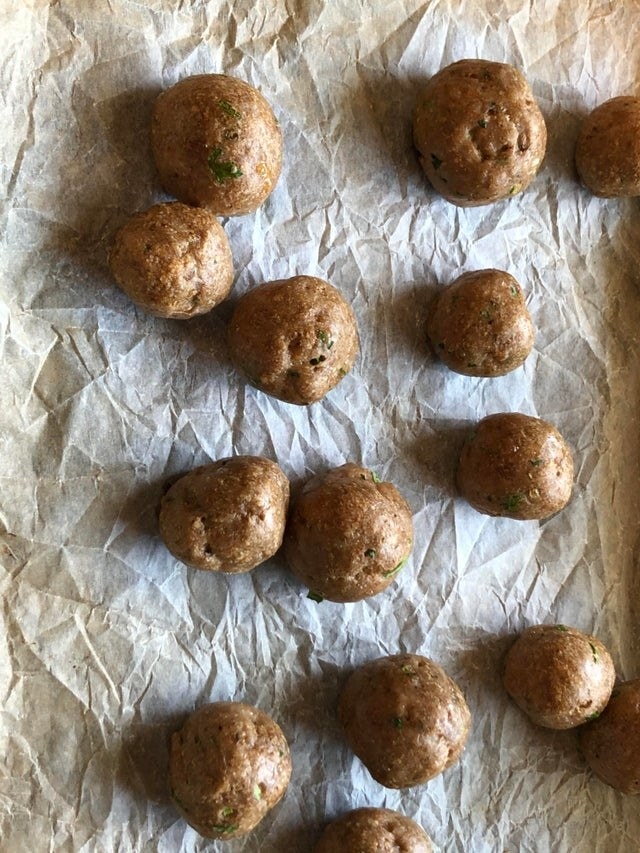 Perfectly shaped meatballs on foil.