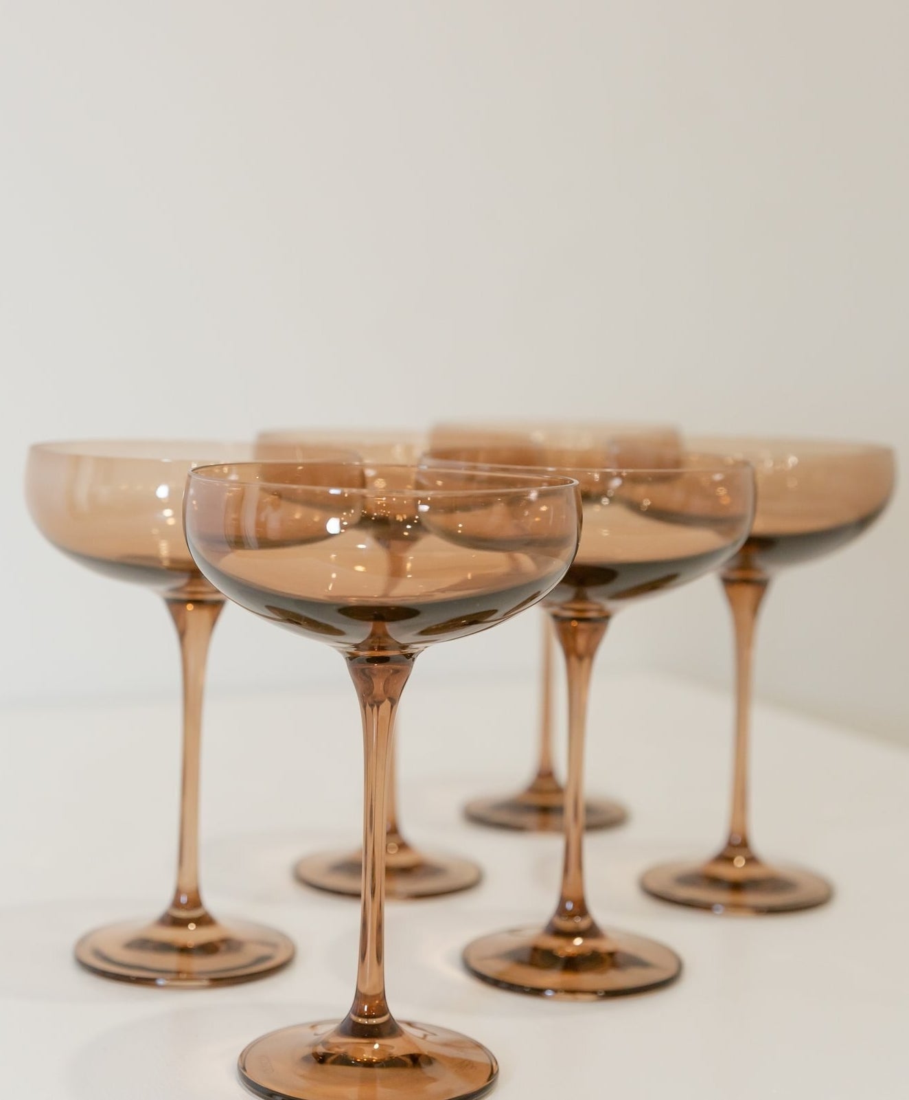 Multiple wine glasses in an amber color