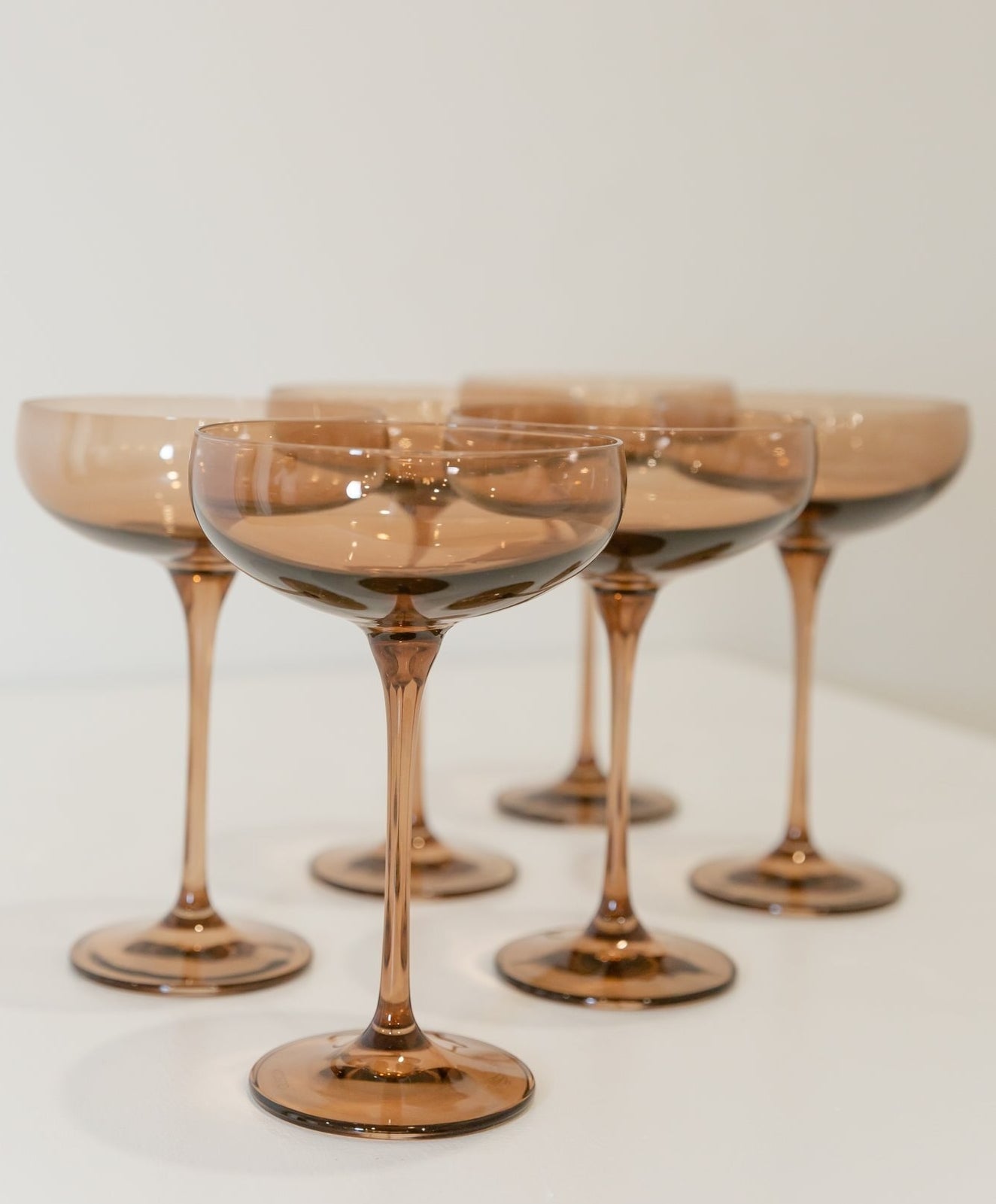 Multiple wine glasses in an amber color
