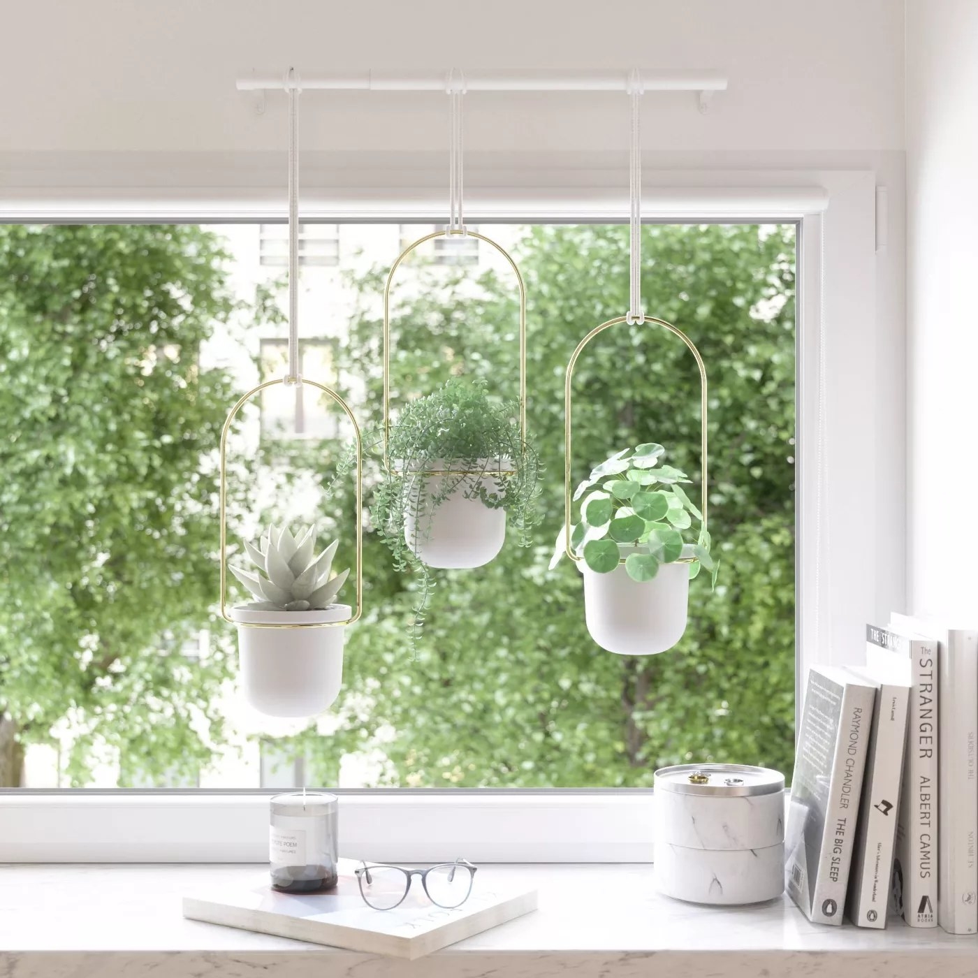 The planter hanging on a kitchen wall with three separate pots at different lengths