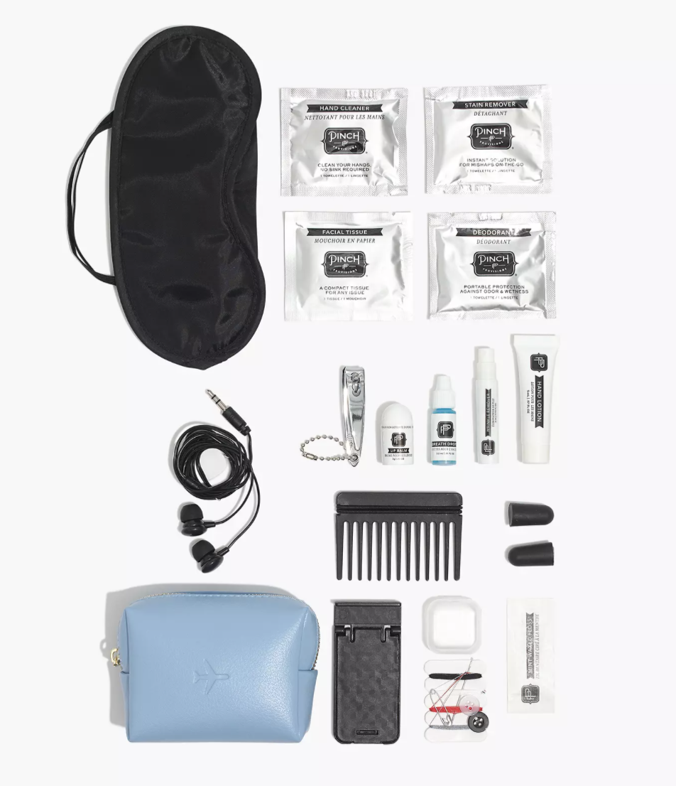 Pinch Provisions kit with travel essentials lined up next to it