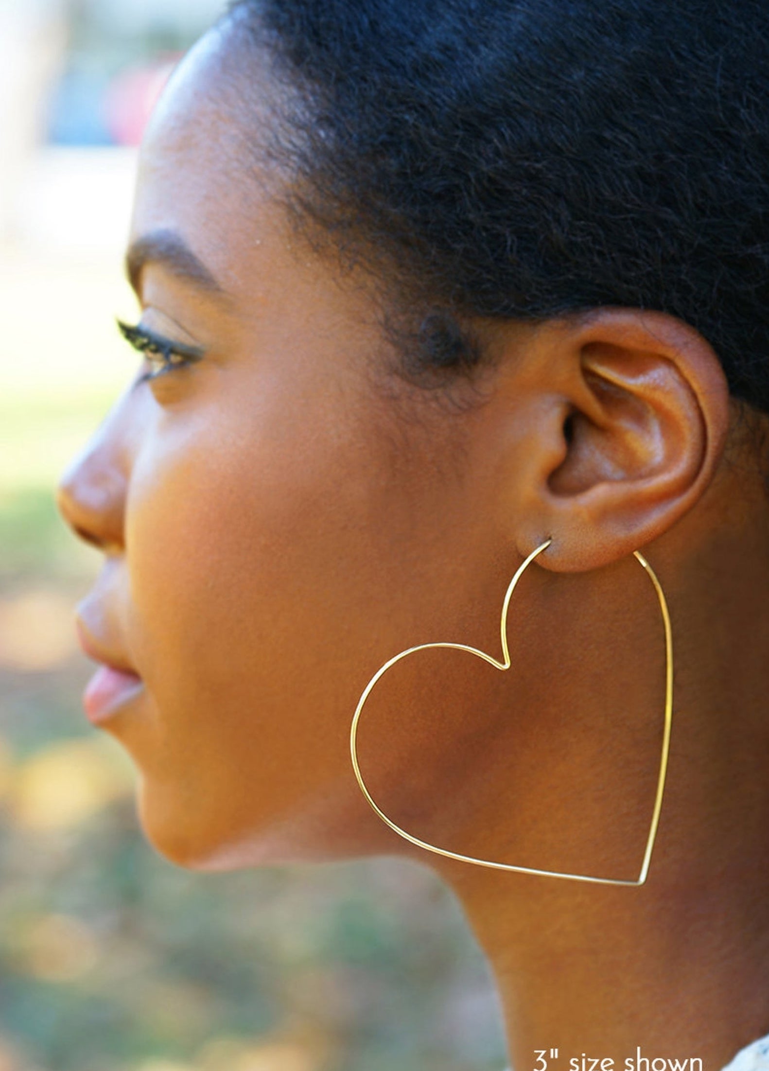 model wearing heart-shaped hoop earrings