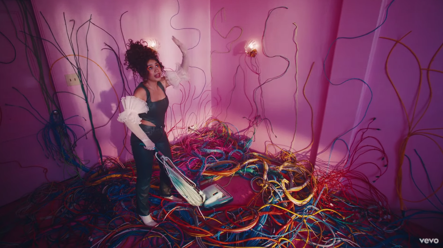 Alessia vacuuming a room full of wires in &quot;Sweet Dream&quot; music video