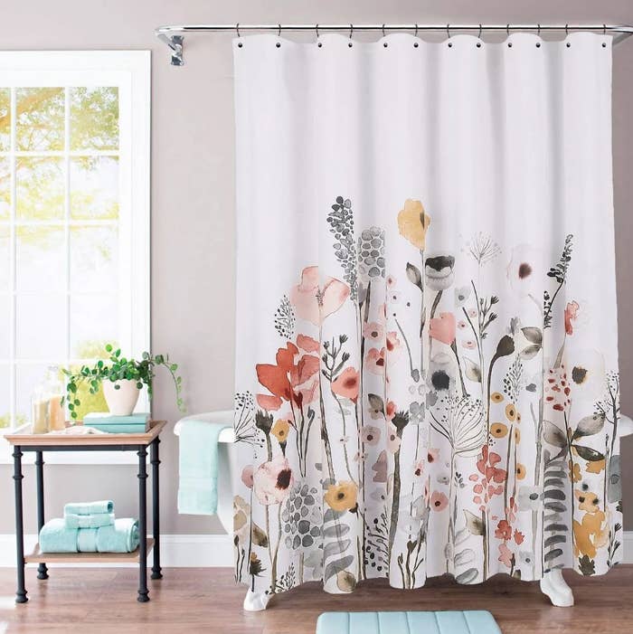 White shower curtain with yellow, pink and black floral design