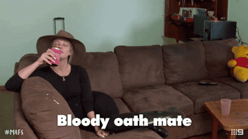 Woman lounging on a couch and saying &quot;Bloody oath, mate&quot;