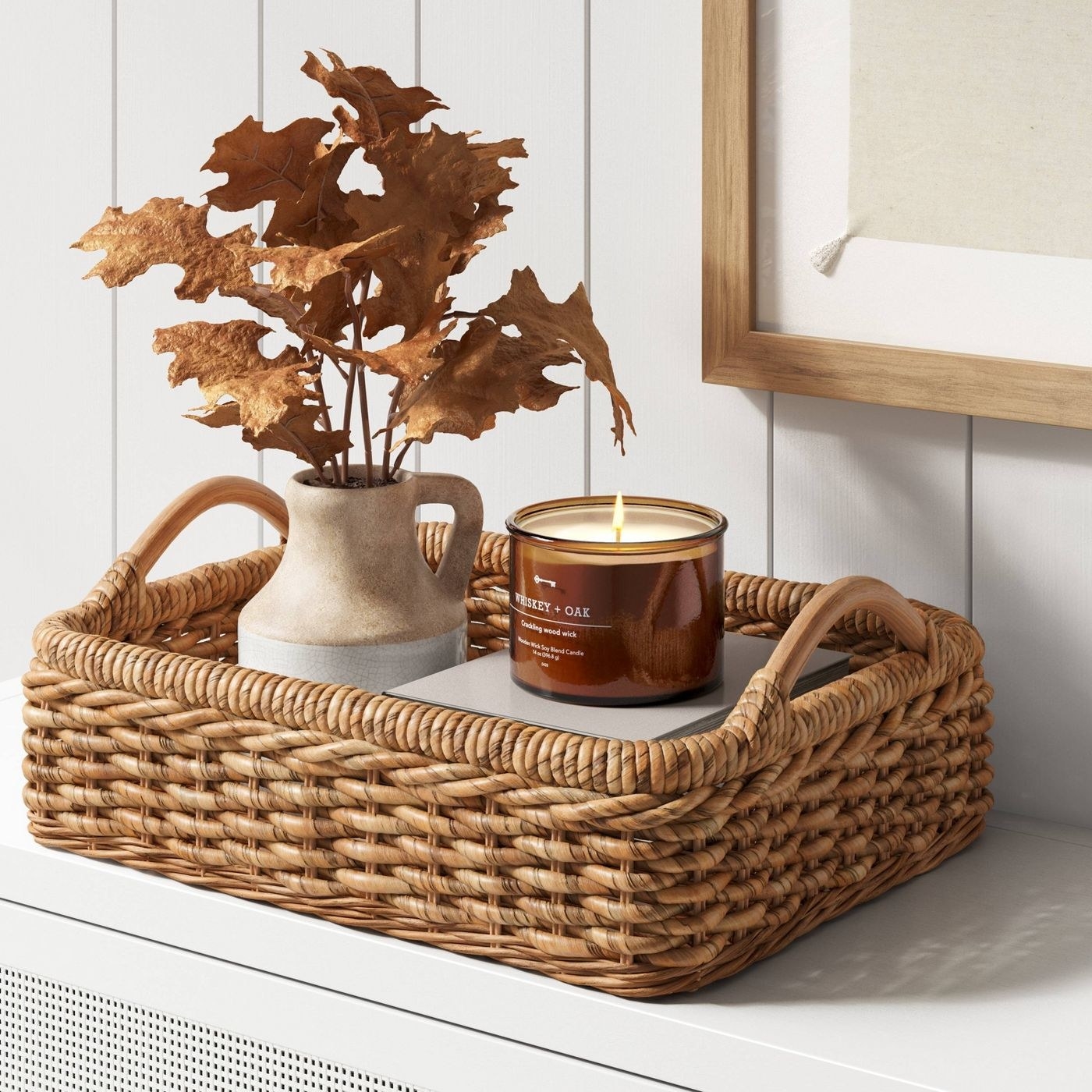 The rattan tray with a candle and vase in it