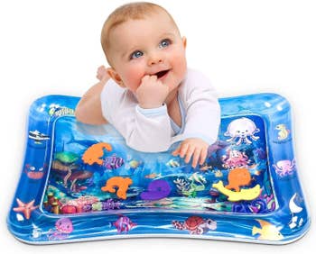 Baby playing on the inflatable water mat