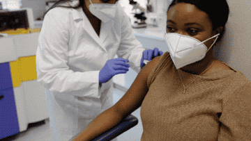 Woman getting a vaccine shot from a doctor