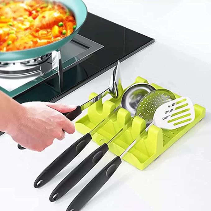 Green plastic rack with four slots for cooking utensils
