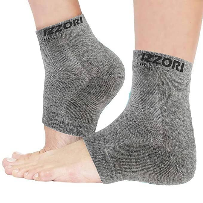 A person wearing the gel heel socks on their feet