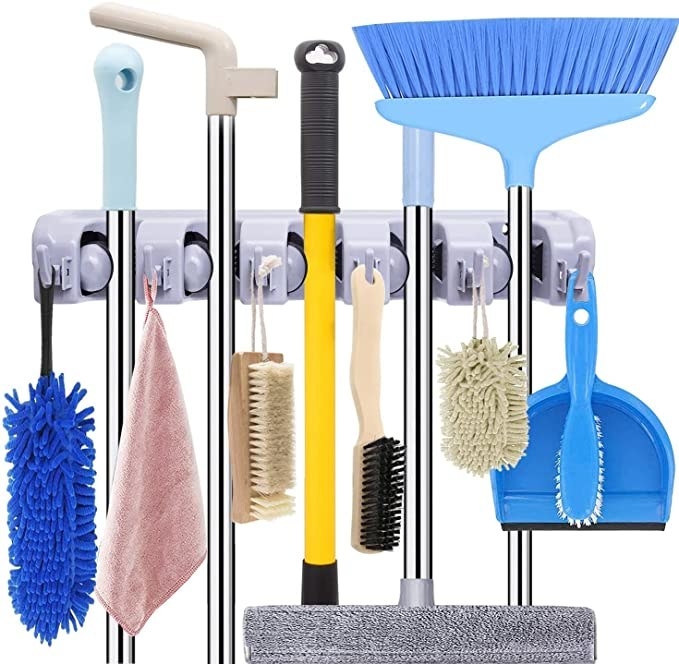 Mops, brushes, brooms and rags hanging on the organiser