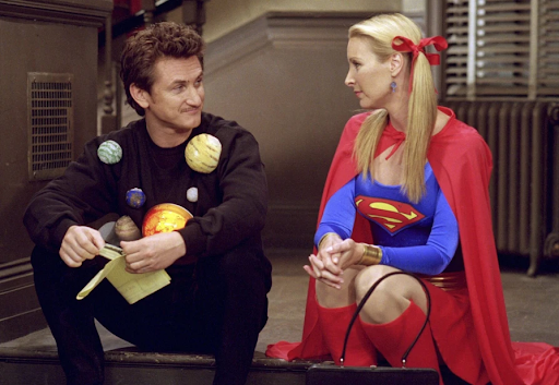 Eric and Phoebe dressed in costumes showing the planetary system and super man