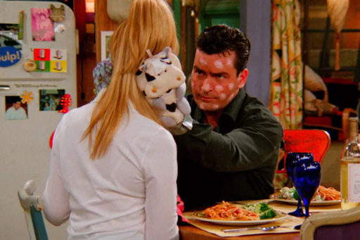 Phoebe and Ryan who is covered in chicken pots and stove mittens eat at the apartment