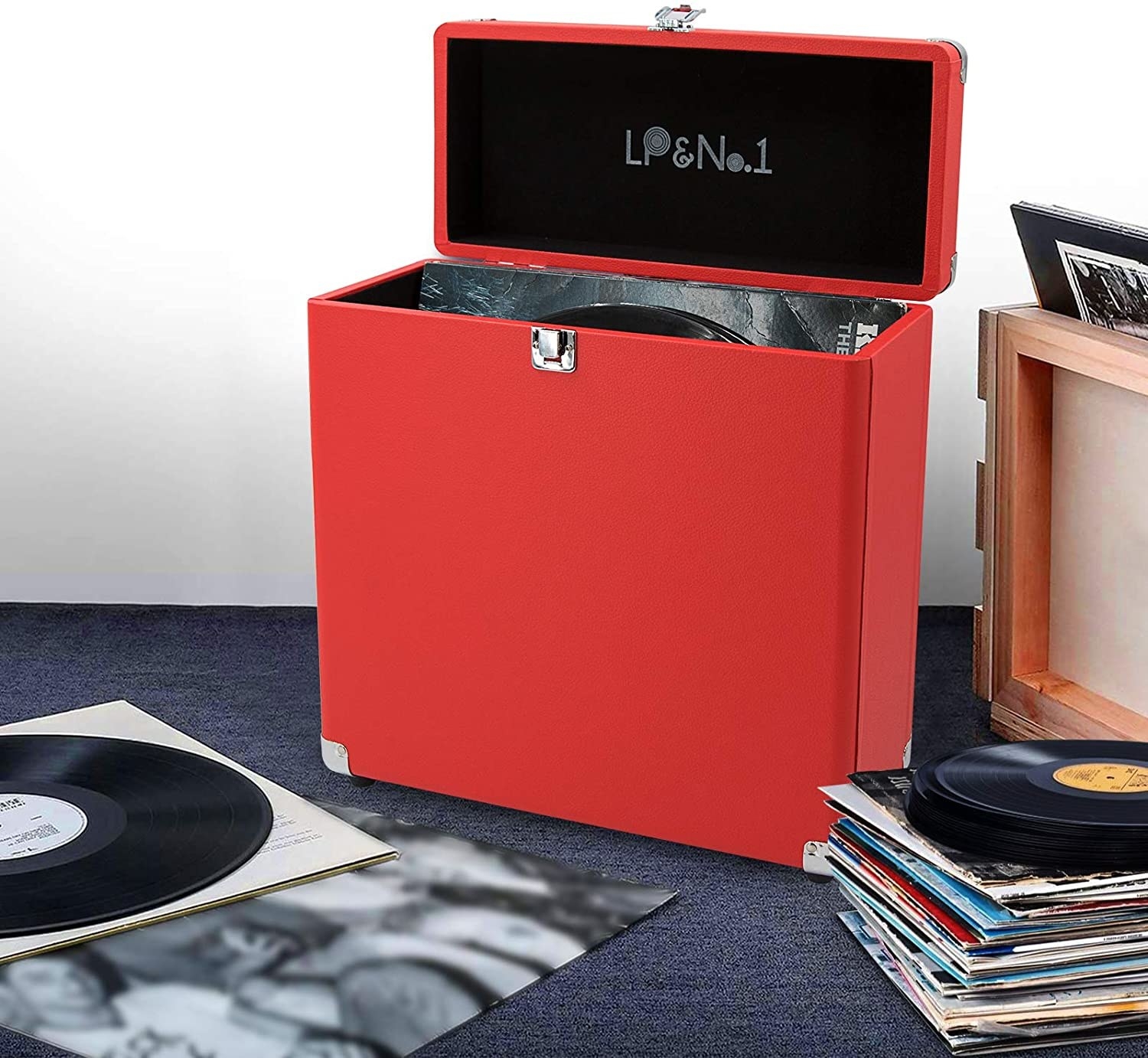 The box on a carpeted floor surrounded by records
