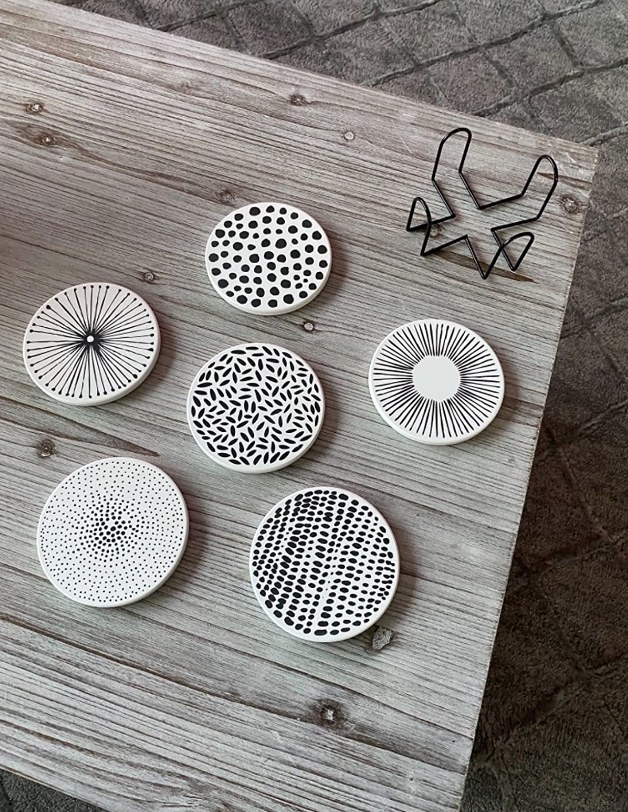 A set of six ceramic stone coasters with unique black/white patterns on each